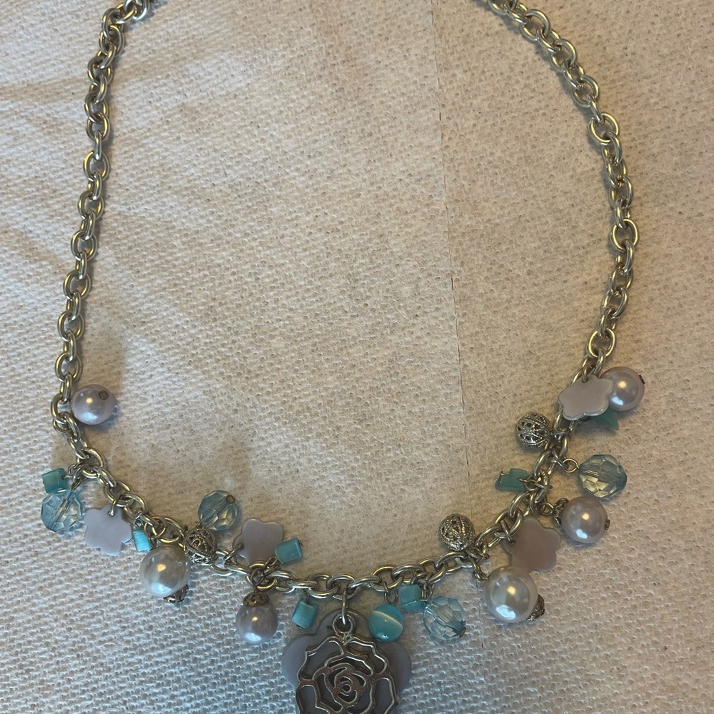 Gold chain with periwinkle and turquoise colored beads.